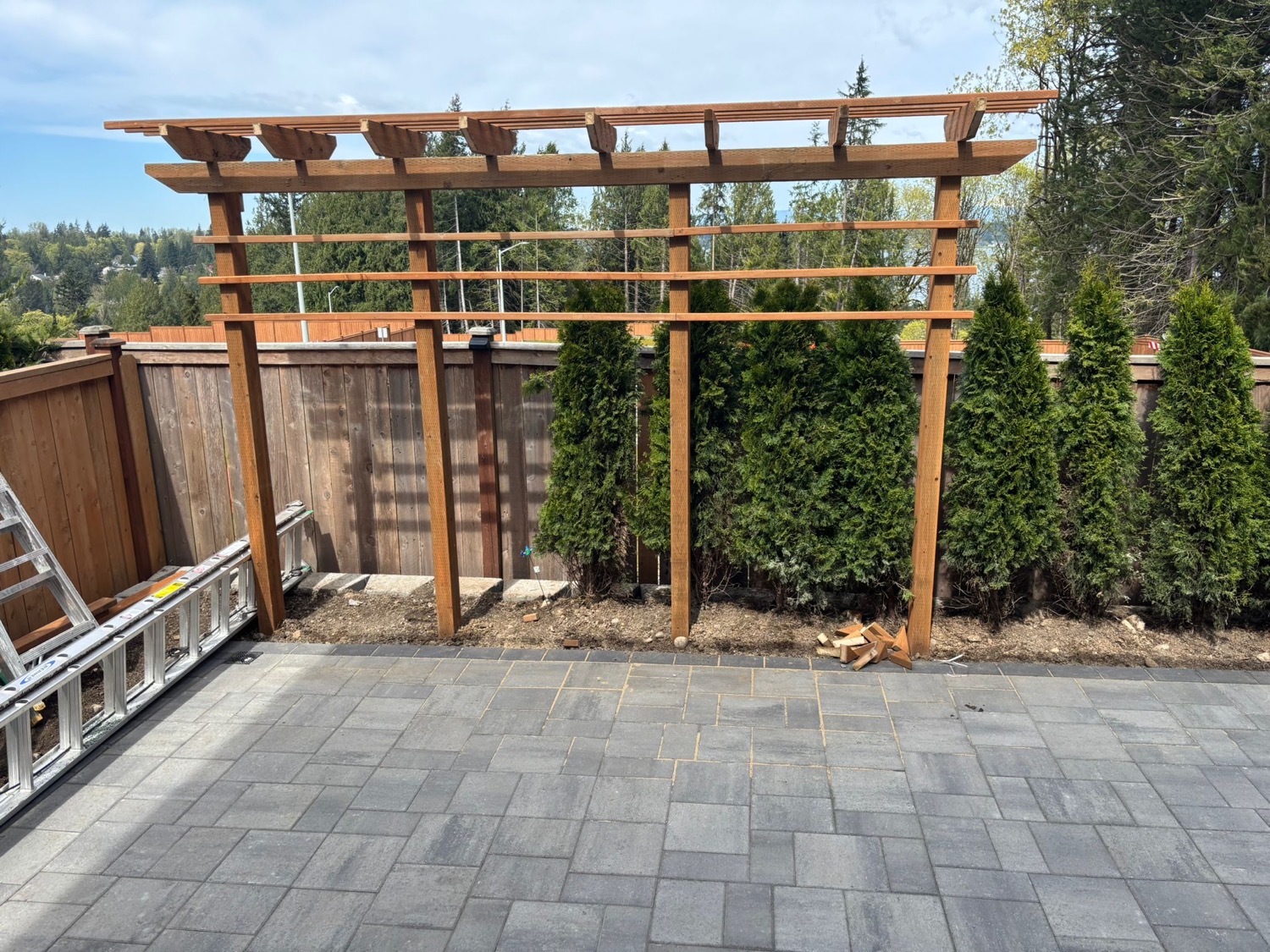 Wood pergola frame over paver patio design